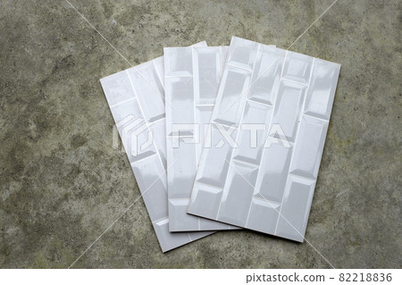 Pile of wall tiles on cement floor 82218836