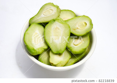 Fresh chayote fruit in white bowl on white background. 82218839