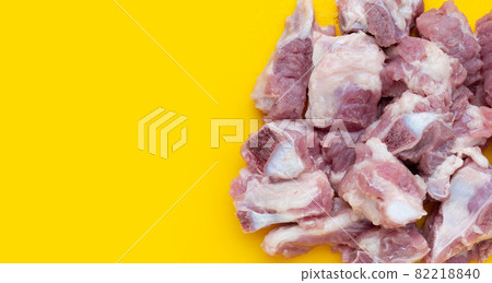 Raw pork ribs on yellow background. 82218840