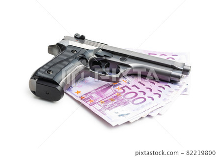 Hand gun and euro banknotes. 82219800