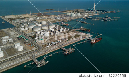 Aerial view oil terminal storage tank, White oil tank storage chemical petroleum petrochemical refinery product at oil terminal, Business commercial trade fuel and energy transport by tanker ship Aerial view oil terminal storage tank, White oil tank storage chemical petroleum petrochemical refinery product at oil terminal, Business commercial trade fuel and energy transport by tanker ship 82220366
