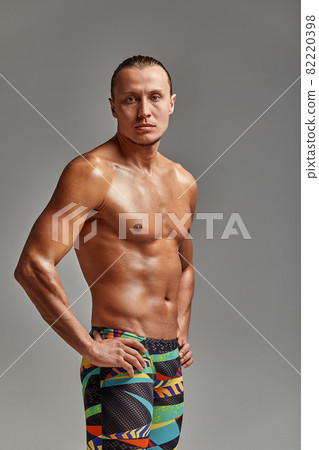 Portrait of a swimmer in a cap and mask, half-length portrait, young athlete swimmer wearing a cap and mask for swimming, copies of space, gray background Portrait of a swimmer in a cap and mask, half-length portrait, young athlete swimmer wearing a cap and mask for swimming, copies of space, gray background 82220398