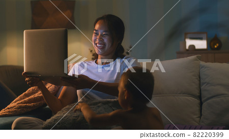 Mother making video call near son in evening Mother making video call near son in evening 82220399