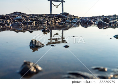 A landscape of a torii floating in the Shiranui Sea at dusk 82220979