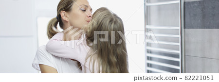 Mom and daughter hug in early morning Mom and daughter hug in early morning 82221051
