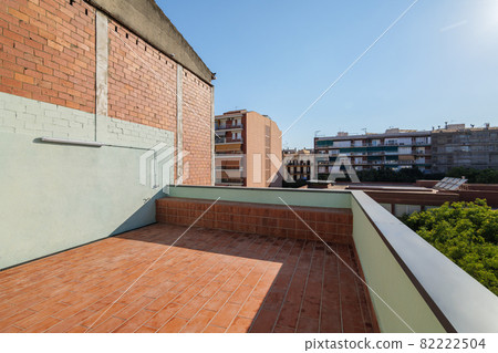 Empty terrace on the roof of modern building in Barcelona, Spain. View to the city and blue sky on sunny day. 82222504