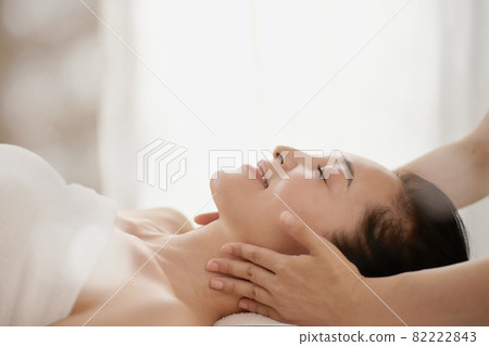 Middle-aged woman receiving a massage at an esthetic salon Middle-aged woman receiving a massage at an esthetic salon 82222843