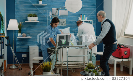 Worried man asking medical team to help sick old wife 82227304