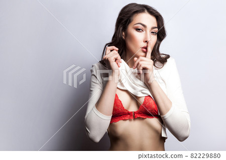 Secret between us, do not tell anyone. Sexy young fashion model undressing Secret between us, do not tell anyone. Sexy young fashion model undressing 82229880
