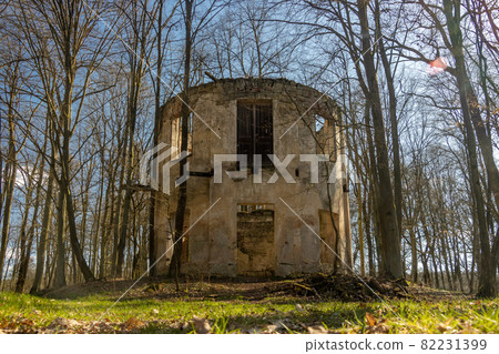The ruin of a circular building between trees with fallen leaves, Czech republic. The ruin of a circular building between trees with fallen leaves, Czech republic. 82231399