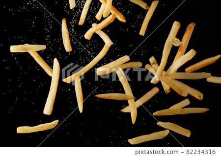 French fries scattered in the air 82234316
