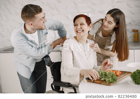 Mature disabled woman cutting vegetables in the kitchen 82236480