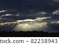 Dark Dramatic Sky with Sunbeams Through Storm Clouds 82238943