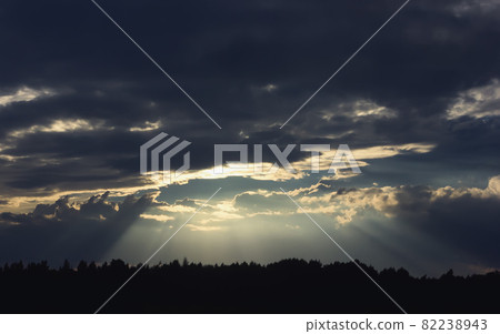 Dark Dramatic Sky with Sunbeams Through Storm Clouds 82238943