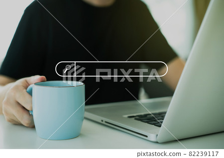 Man using laptop computer for browsing website. 82239117