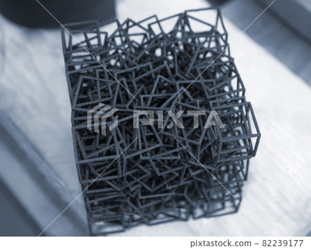 Object printed on industrial powder 3D printer close-up. Object printed on industrial powder 3D printer close-up. 82239177