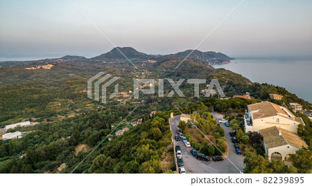 Sunset over coast of Corfu with Pelekas village, Greece. Sunset over coast of Corfu with Pelekas village, Greece. 82239895