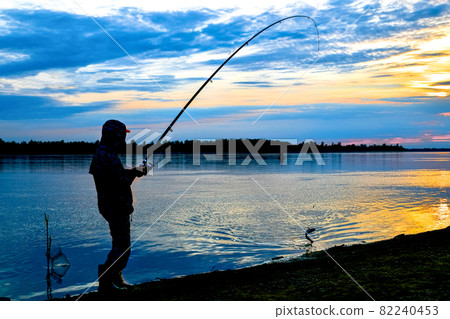 Successful fishing on the river at sunset. 82240453