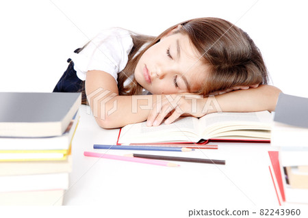 Tired little child girl sleeping on the desk at school. Tired little child girl sleeping on the desk at school. 82243960