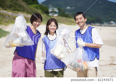 Men and women picking up trash 82245671