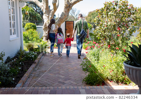Back view of caucasian family heading to school and work 82246334