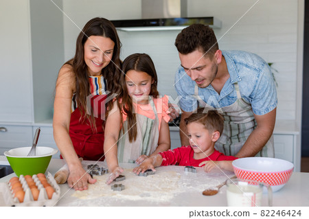 Happy caucasian family baking together, making cookies in kitchen 82246424