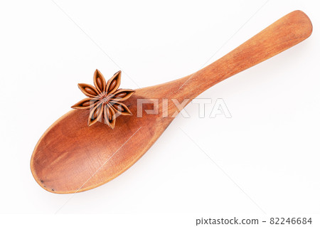Close up chinese star anise in wooden spoon isolate on white background. Dried star anise spice fruits top view and copy space. Close up chinese star anise in wooden spoon isolate on white background. Dried star anise spice fruits top view and copy space. 82246684