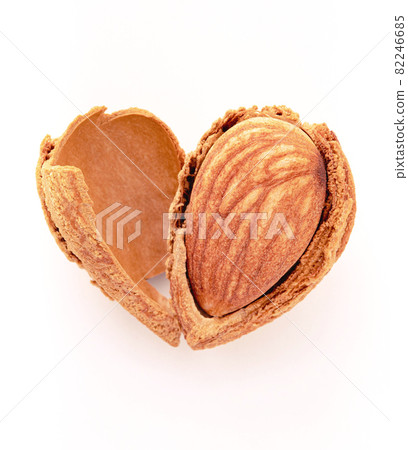 Close up almonds nut shell cracked in heart shape isolated on white background. Love healthy eating concept. Close up almonds nut shell cracked in heart shape isolated on white background. Love healthy eating concept. 82246685