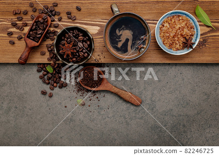Roasted coffee beans with coffee cup setup on dark stone background. 82246725