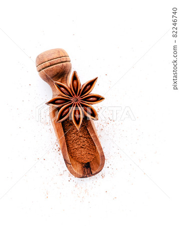Close up chinese star anise in wooden scoop isolate on white background. Dried star anise spice fruits top view and copy space. Close up chinese star anise in wooden scoop isolate on white background. Dried star anise spice fruits top view and copy space. 82246740