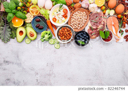 Ketogenic low carbs diet concept. Ingredients for healthy foods selection set up on white concrete background. Ketogenic low carbs diet concept. Ingredients for healthy foods selection set up on white concrete background. 82246744