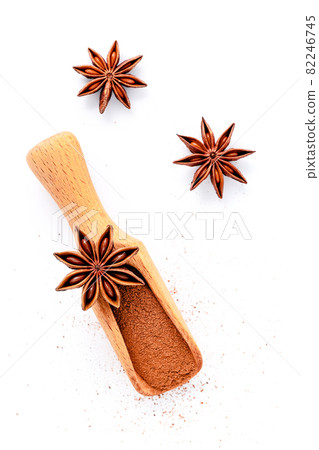 Close up chinese star anise in wooden scoop isolate on white background. Dried star anise spice fruits top view and copy space. Close up chinese star anise in wooden scoop isolate on white background. Dried star anise spice fruits top view and copy space. 82246745