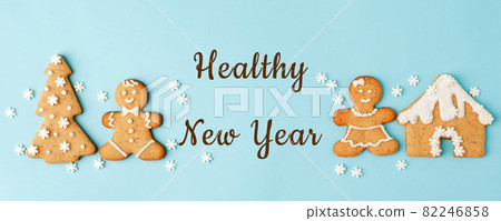 Healthy New Year's Christmas set of ginger biscuits - man, house, tree glazed sugar icing decoration on blue background, minimal seasonal winter holiday card, banner, flyer, coupon, stay home Healthy New Year's Christmas set of ginger biscuits - man, house, tree glazed sugar icing decoration on blue background, minimal seasonal winter holiday card, banner, flyer, coupon, stay home 82246858