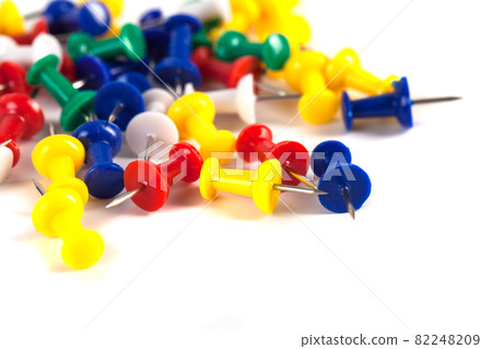 Mark pin pile on the white background in office, tacks 82248209