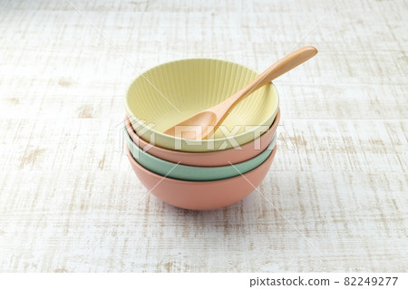 Stacked colorful bowls and spoons 82249277