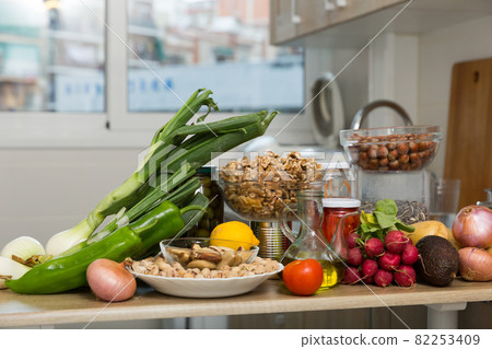 Vegetables and nuts on kitchen tabletop 82253409