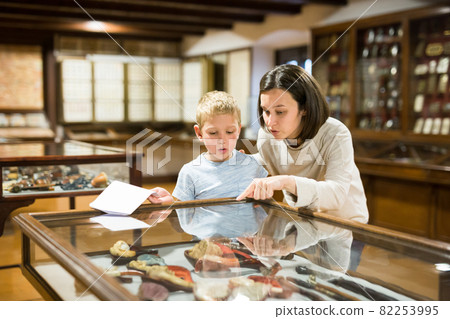 Woman and boy exploring artworks in museum Woman and boy exploring artworks in museum 82253995