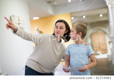 Woman and boy observing sculptures exhibition Woman and boy observing sculptures exhibition 82254063