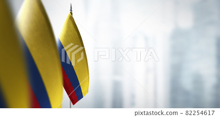 Small flags of Colombia on a blurry background of the city Small flags of Colombia on a blurry background of the city 82254617
