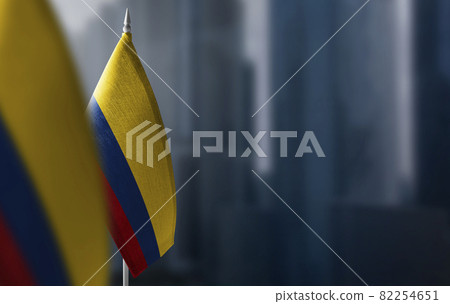 Small flags of Colombia on a blurry background of the city 82254651