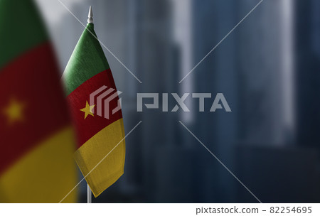 Small flags of Cameroon on a blurry background of the city Small flags of Cameroon on a blurry background of the city 82254695