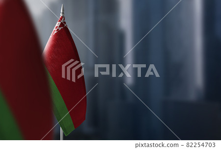 Small flags of Belarus on a blurry background of the city 82254703