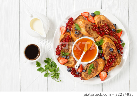 crispy sweet toasts with fresh berries and honey crispy sweet toasts with fresh berries and honey 82254953