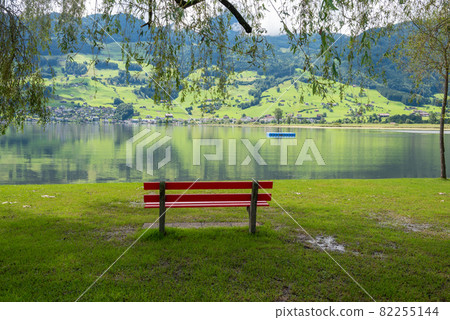A calm place to rest and relax. An empty wooden bench. Switzerland A calm place to rest and relax. An empty wooden bench. Switzerland 82255144