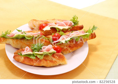 Sandwich baguette bread prosciutto ham cheese cherry tomato 82256528