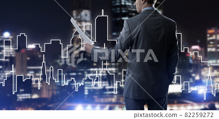 Man architect or engineer presenting construction concept and holding documents in hand Man architect or engineer presenting construction concept and holding documents in hand 82259272