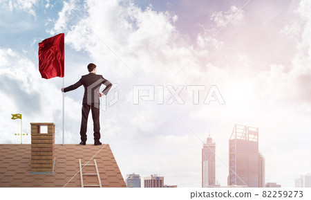 Young businessman with flag presenting concept of leadership. Mixed media Young businessman with flag presenting concept of leadership. Mixed media 82259273