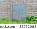 Masonry walls and rusty blue iron doors 82262068