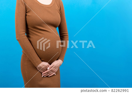 urinary incontinence during pregnancy. Abdominal pain during pregnancy. Maternity healthcare concept on colored background urinary incontinence during pregnancy. Abdominal pain during pregnancy. Maternity healthcare concept on colored background 82262991