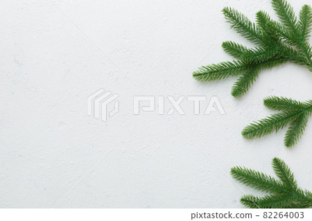 Christmas holiday background with copy space for advertising text. Fir branches on color background . Flat lay, top view 82264003